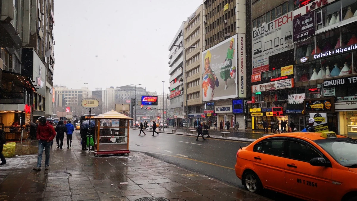 Yağışlı havada şehir merkezinde araçlar ve yayalar