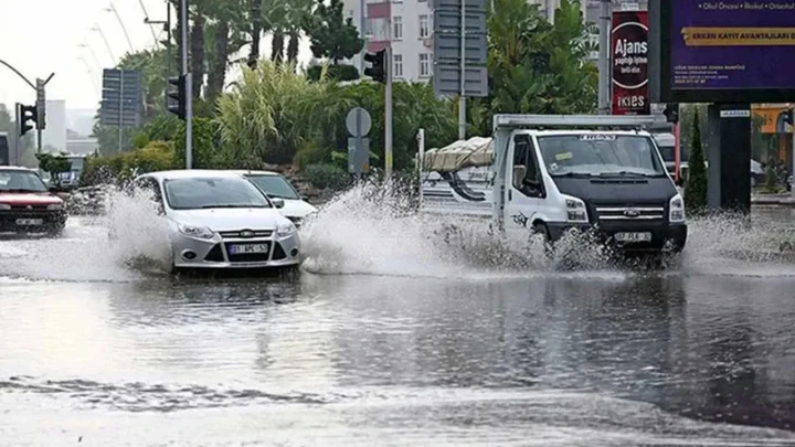 Ankara’da su birikintisinden geçerken çevreye su sıçratan otomobiller