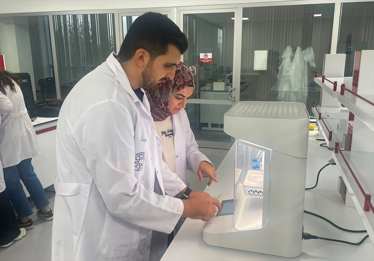Laboratuvarda biyoyazıcı cihazıyla çalışan iki araştırmacı