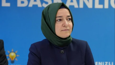 Fatma Betül Sayan Kaya, AKP teşkilatının mavi arka planlı bir salonunda otururken