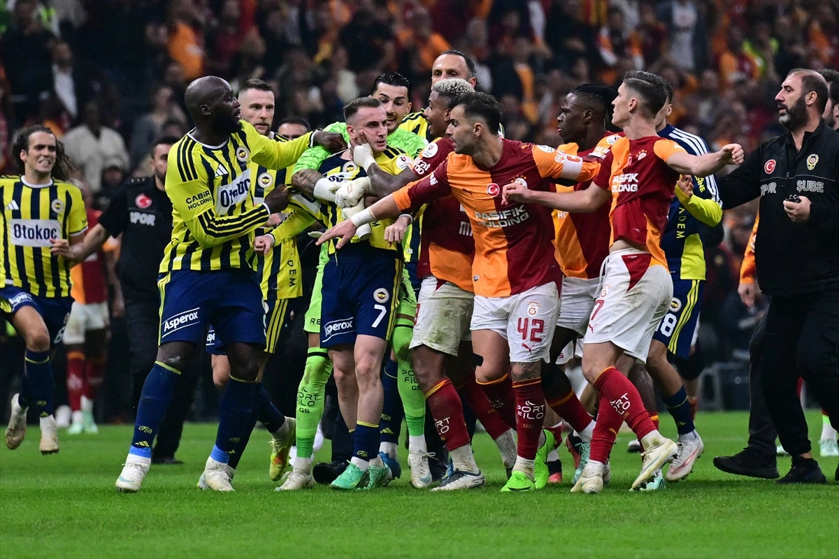 Galatasaray ve Fenerbahçe oyuncuları sahadaki gerginlikte birbirine yaklaşırken takım arkadaşları araya giriyor