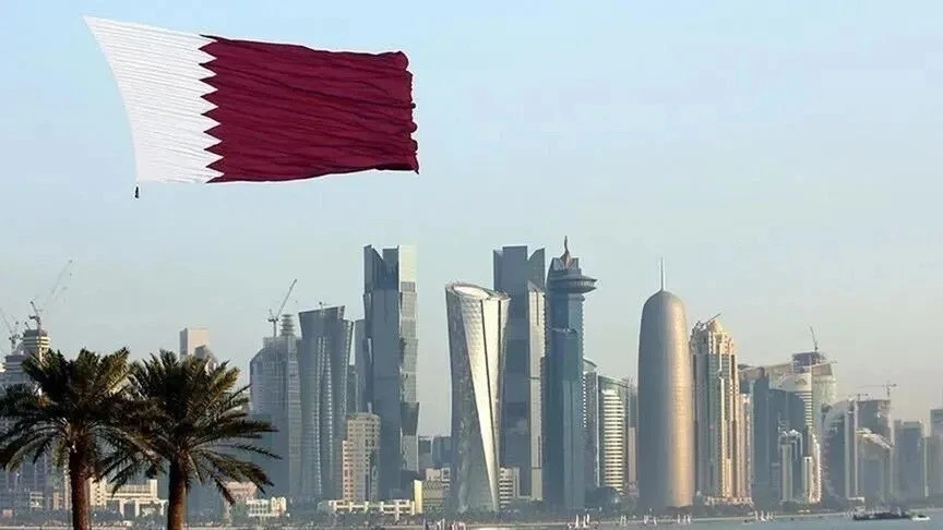 Katar bayrağı önünde Doha silüeti